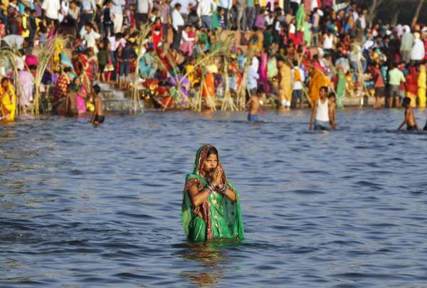 Chhath Puja: Women devotees pay obeisance to rising sun along ghats on Yamuna in Delhi