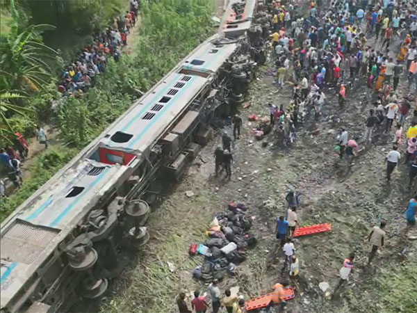India opens rail disaster probe as trains crawl through crash site