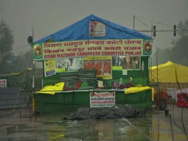 Protesting farmers make their tents waterproof amid heavy rainfall