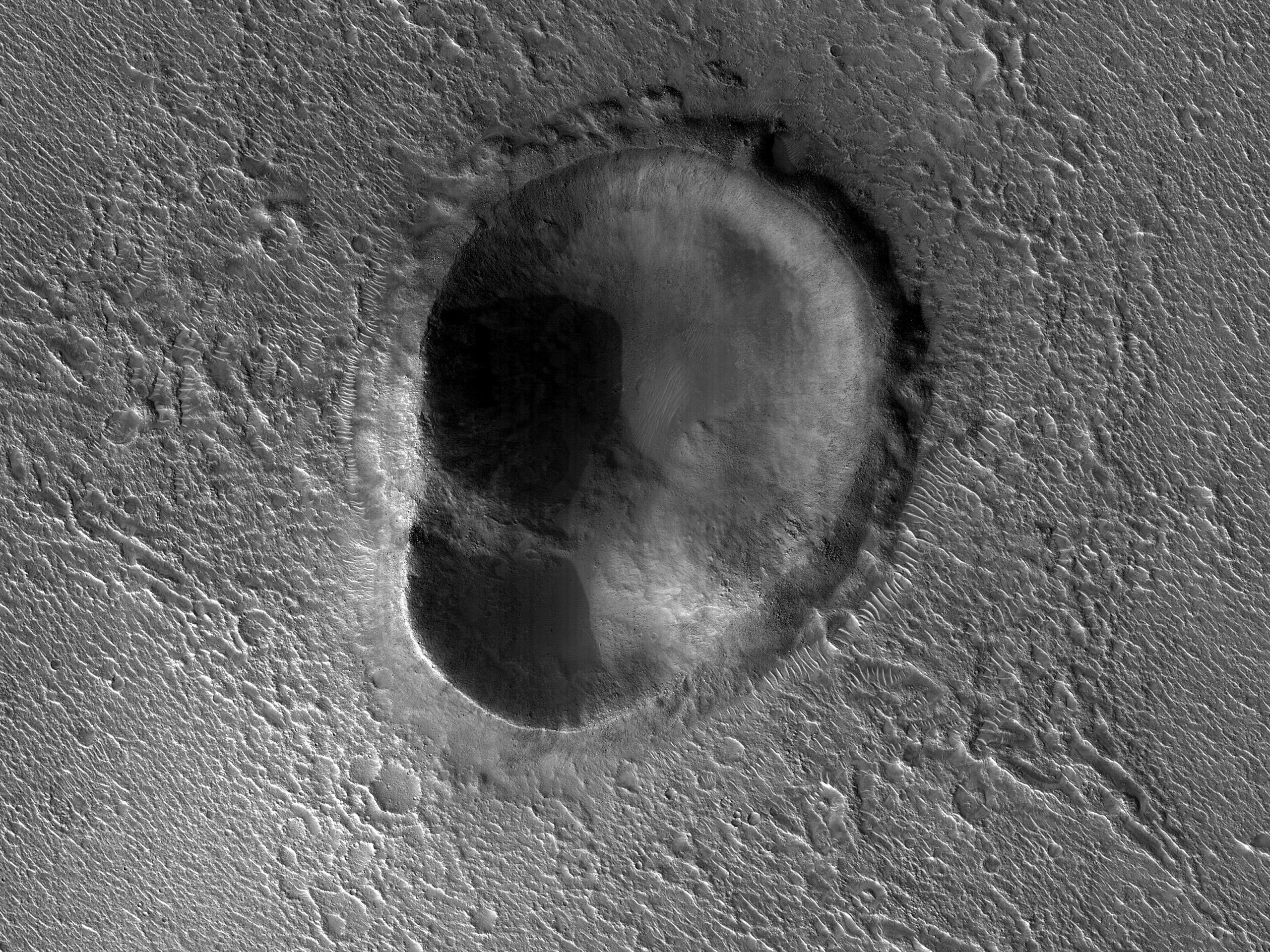 This odd-shaped Martian impact crater looks like an ear: See pic