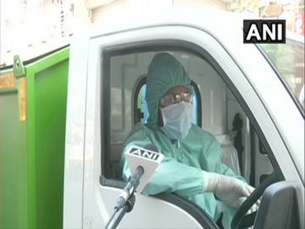 Sanitation workers wear protective gear for collecting garbage from houses of quarantined in Paharganj