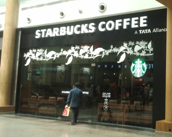 UPDATE 2-Starbucks sees hit as coronavirus prompts over 2,000 China store closures