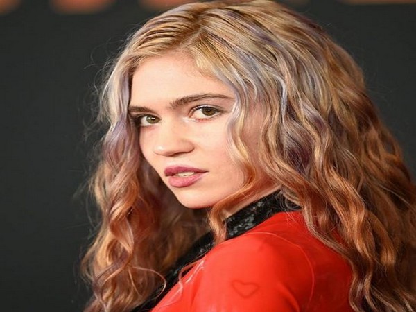 Grimes shares picture featuring tattoo of 'beautiful alien scars'