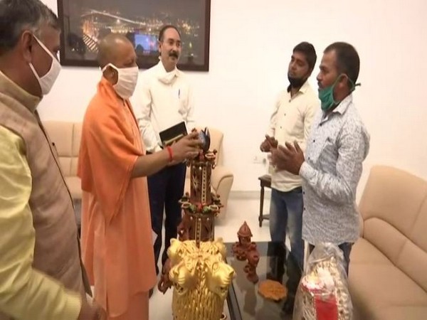 Yogi Adityanath buys products presented to him by artisans of UP's 'Mati Kala Hunar Bazar'