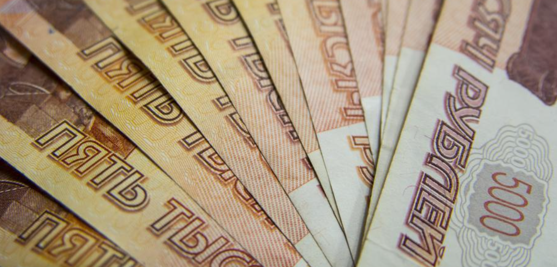 Rouble firms past 52 against dollar for first time since May 2015