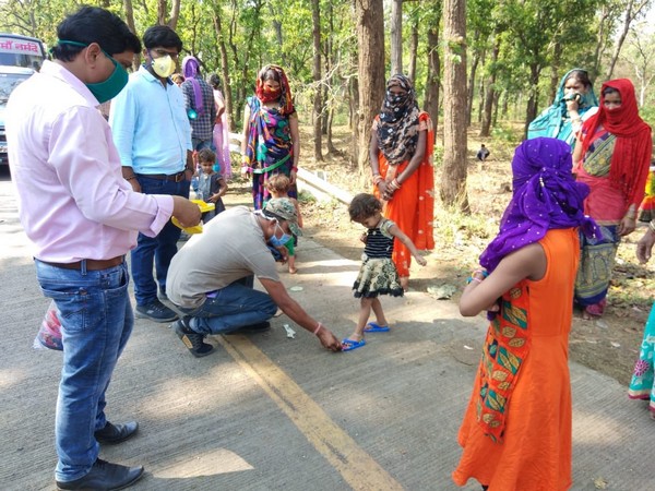 Slippers being distributed to migrants making their way via Chhattisgarh