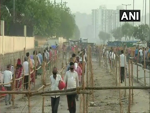 People arrive at Delhi's Ghazipur market to buy essentials amid lockdown
