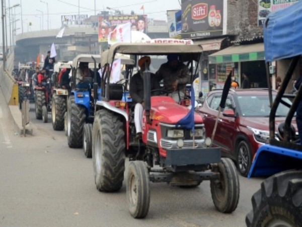Indian farmers ride flag-bedecked tractors in Republic Day protest