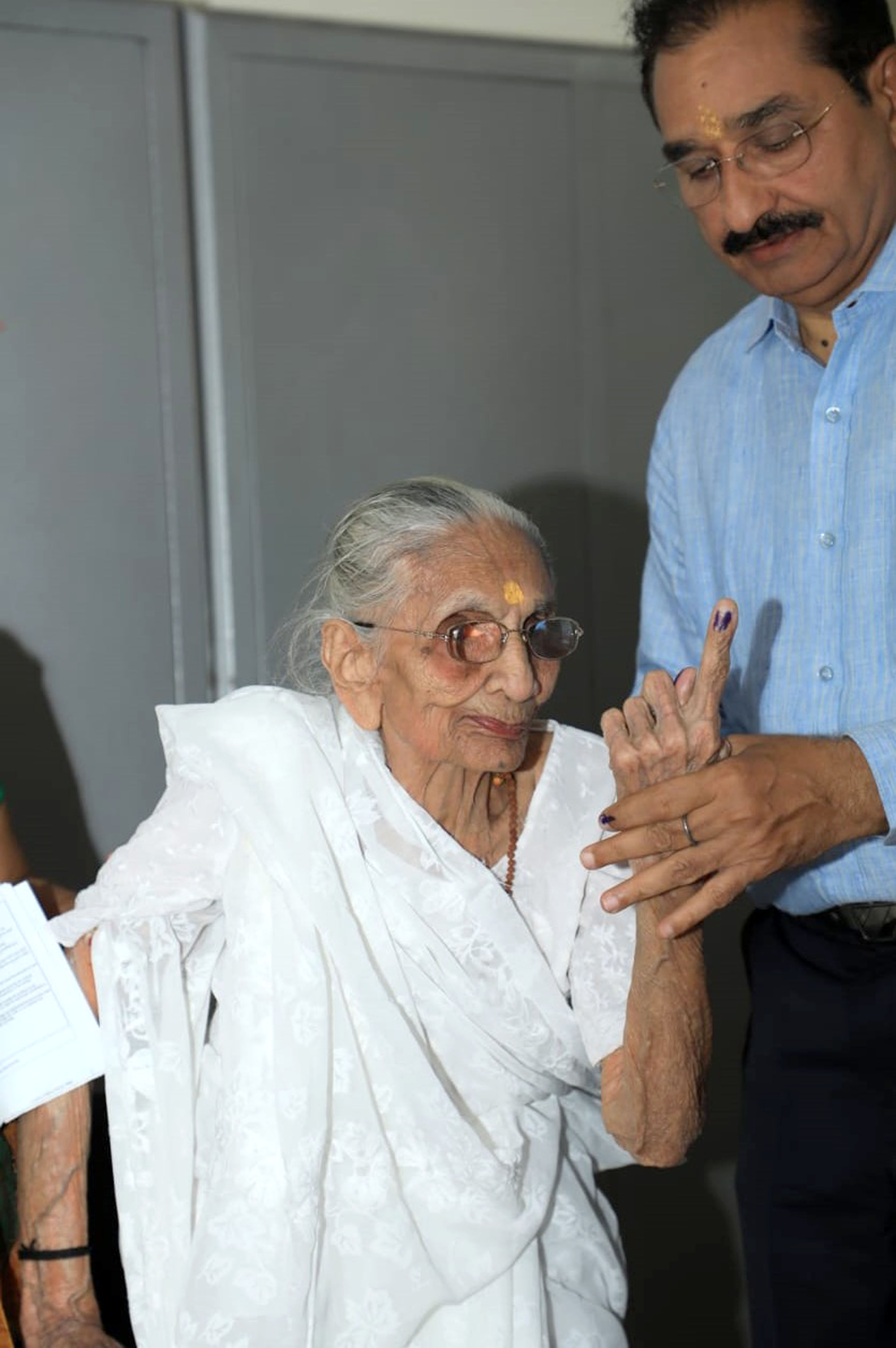 Modi's mother greets BJP supporters outside her house