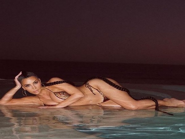 Kim Kardashian shares stunning snakeskin-print bikini picture as she goes for 'night swim'