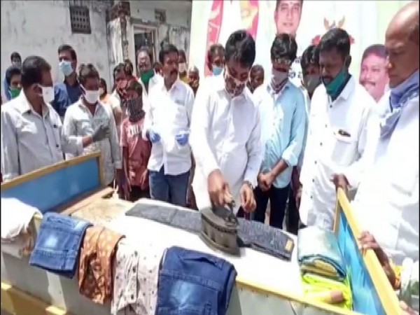 MLA B Madhusudan Reddy washes, irons clothes at washermen union's facilitation programme 