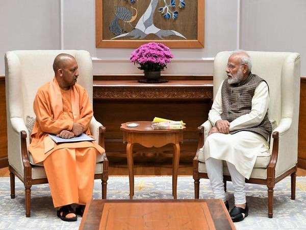 Adityanath tweets photos of him taking a walk with Modi, speaks about 'making new India'