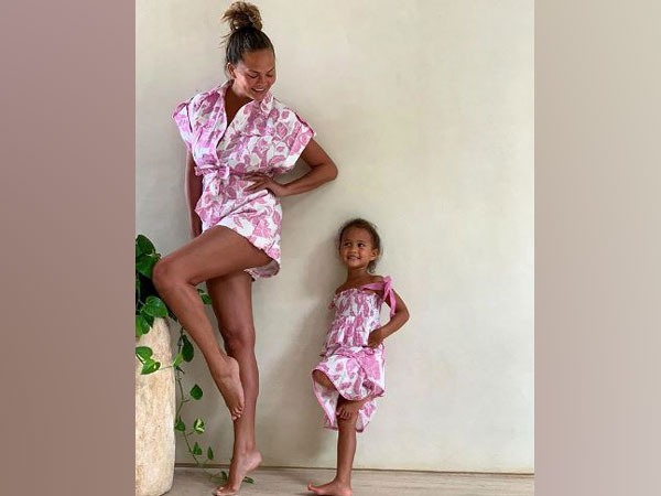 Chrissy Teigen twins with daughter Luna in pink