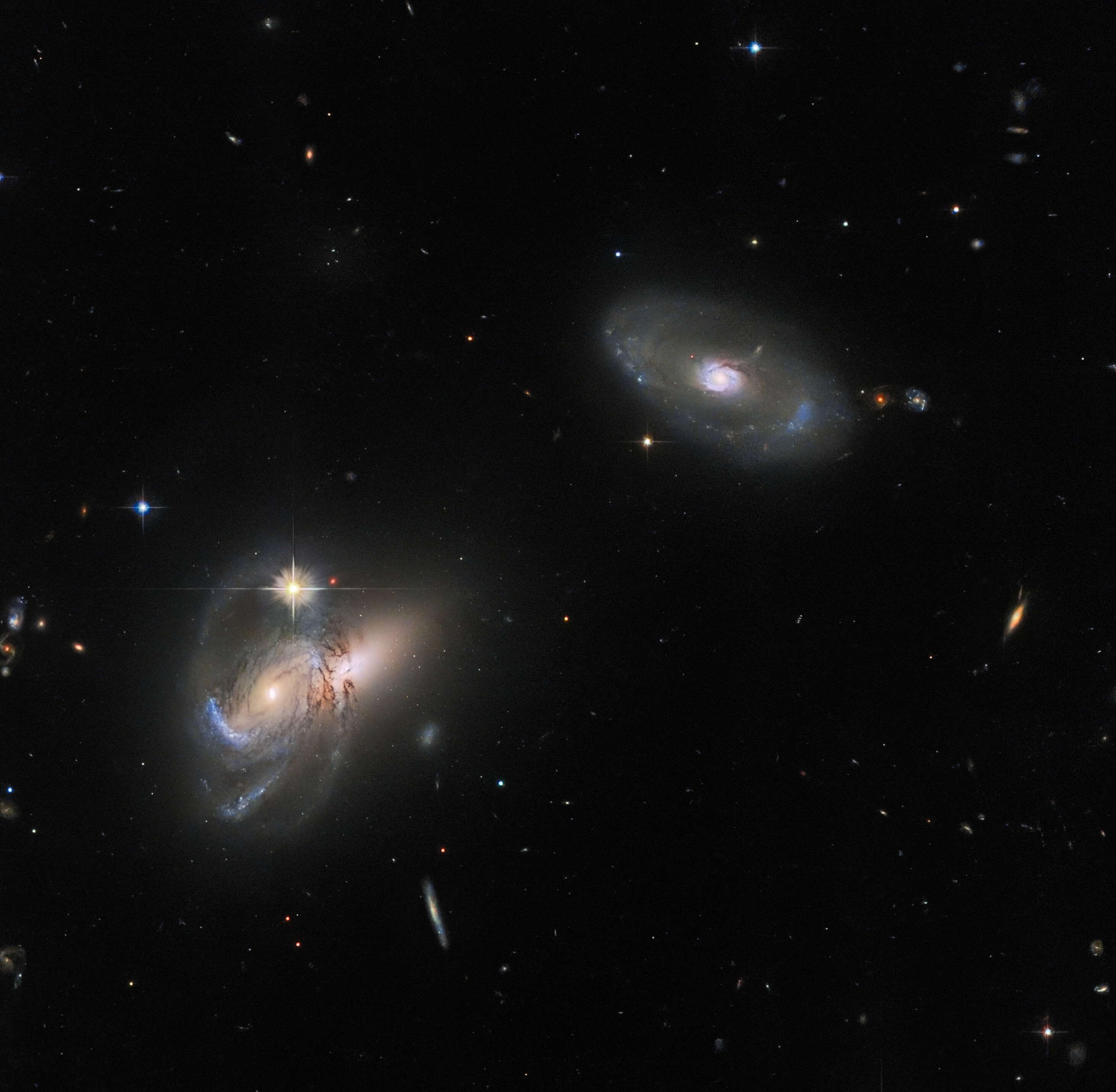 Check out this luminescent Hubble image featuring multiple galaxies