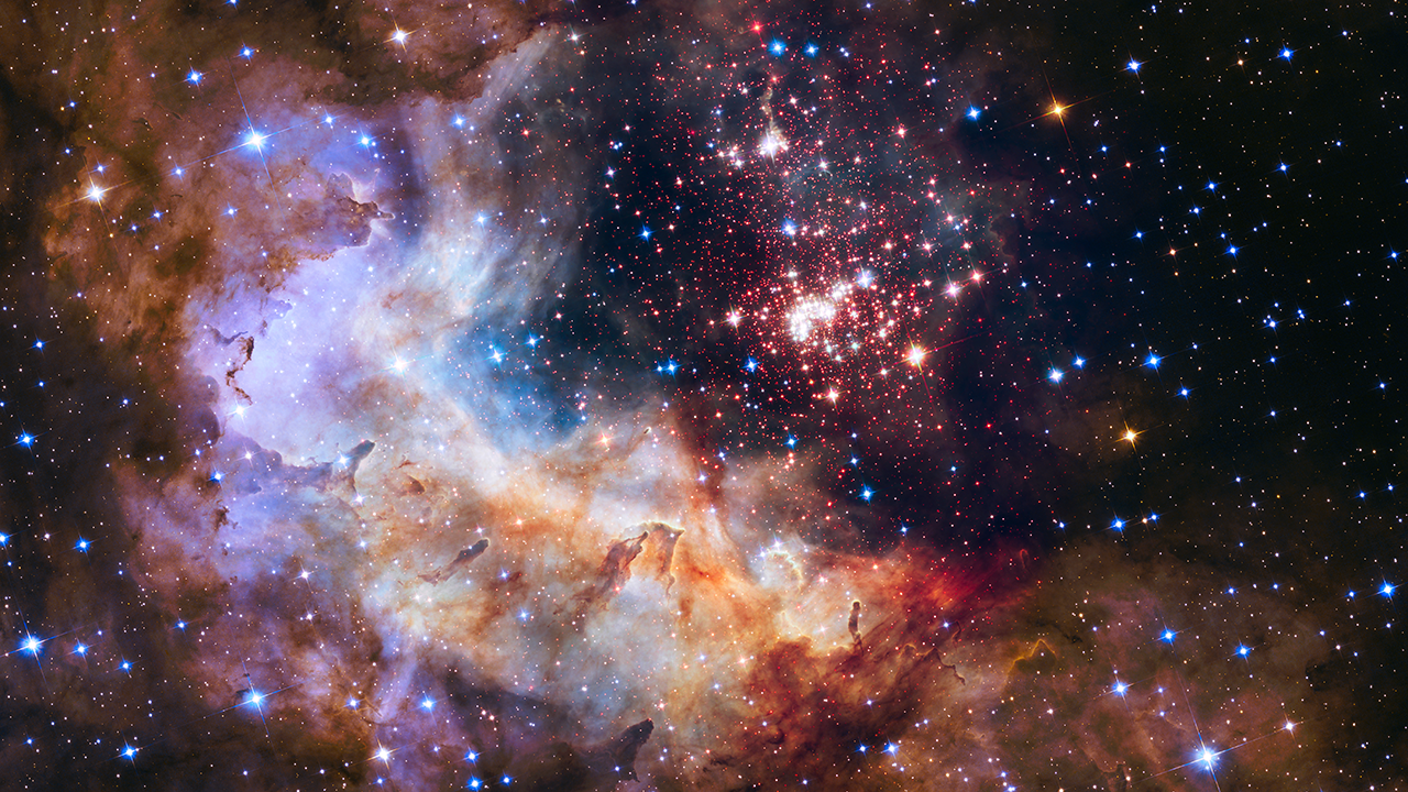 Hubble pierces through the dusty veil enshrouding this sparkling stellar nursery