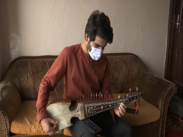 Kashmiri boy inspiring youth to learn traditional musical instrument Rabab