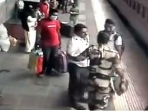 Security personnel help man who fell between platform, track