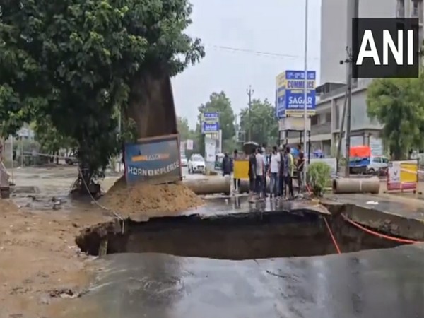 As road caves in during heavy rain, massive sinkhole created in Ahmedabad's Shela