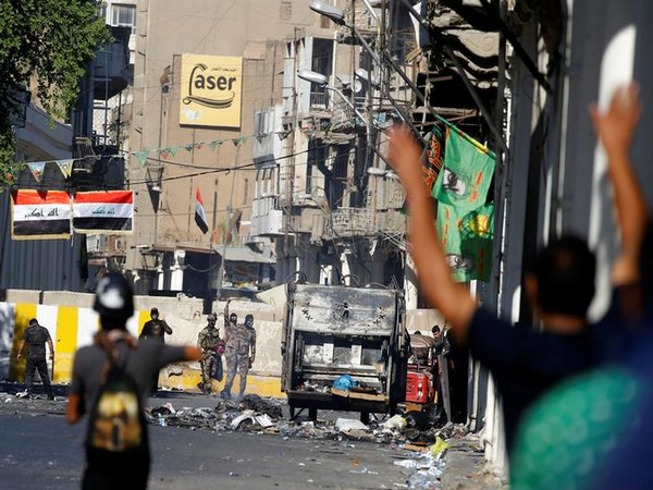 UPDATE 1-Iraqi police clash with protesters, try to clear main sit-ins in Baghdad and Basra