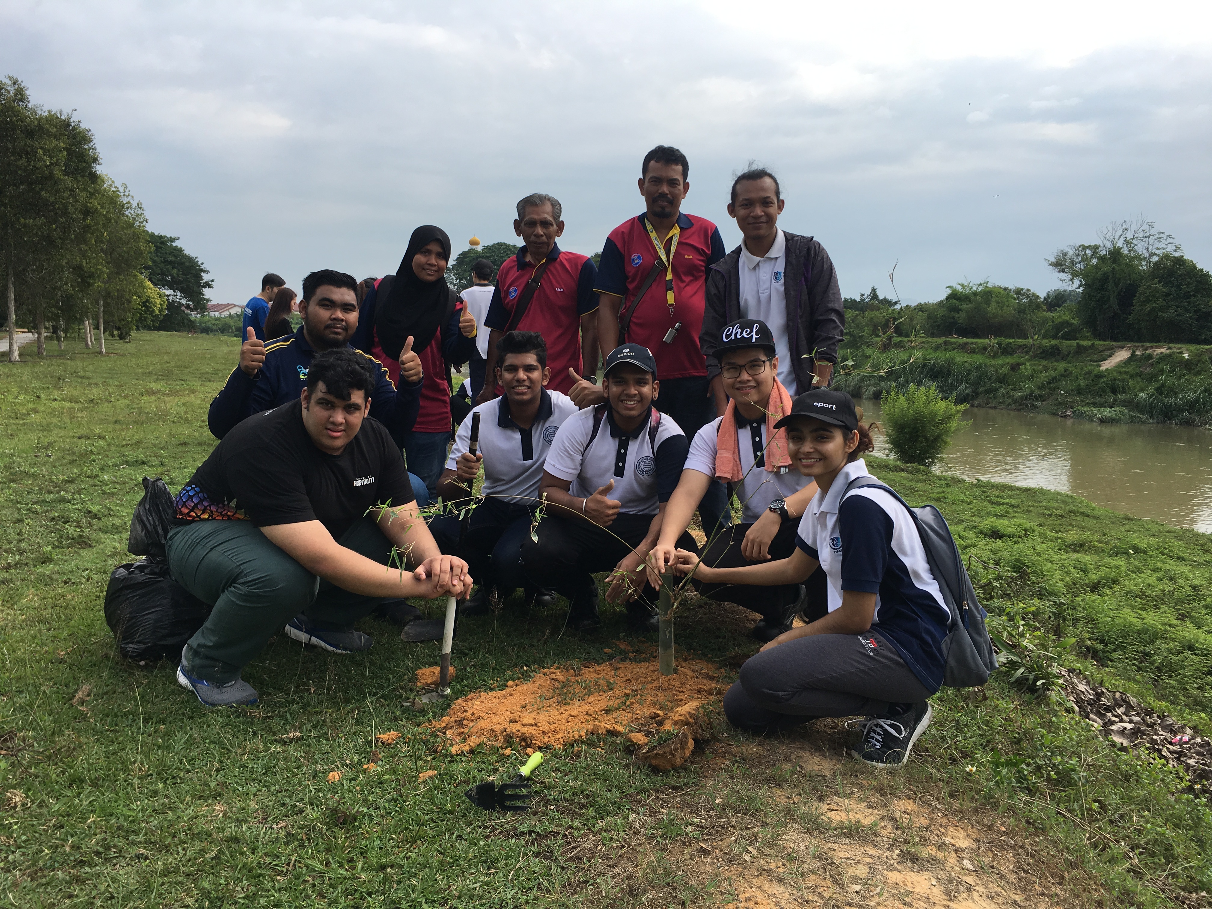 University students and locals plant trees at Kinta River in Malaysia 